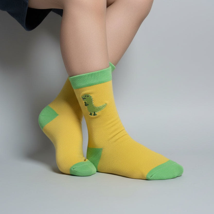 Yellow socks with green accents on a plane surface